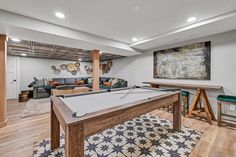 a game room with a pool table and couches