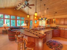 a large kitchen with an island in the middle and lots of stools around it