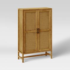 a wooden cabinet with two doors on the front and one door open to reveal a wicker