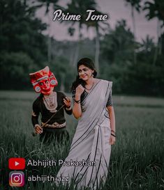 a woman in white sari standing next to a man wearing a mask on his face