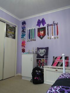 a bedroom with purple walls and decorations on the wall