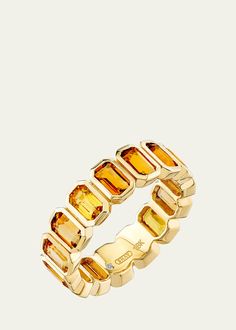 a gold ring with citrine stones on it