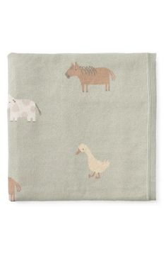 a blanket with animals and horses on it