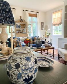 a vase sitting on top of a table in a living room next to a couch