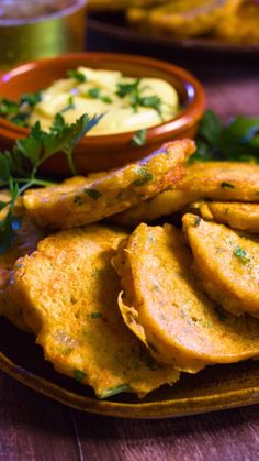 some food is sitting on a plate with dipping sauce