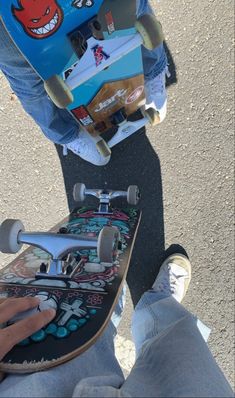 someone is holding their skateboard in the street