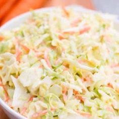 a white bowl filled with coleslaw and carrots