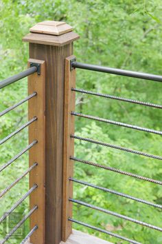 a close up of a wooden fence with metal bars on the top and bottom part