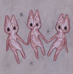 three little alien dolls are standing next to each other with their hands in the air