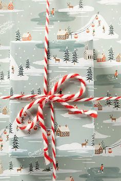 a wrapped christmas present with candy canes on it