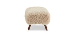 the foot stool is made out of sheep's wool and has wooden legs, which are