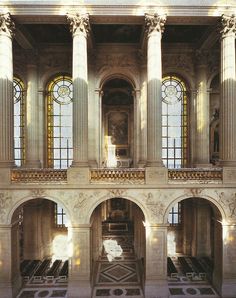 the interior of a building with columns and windows