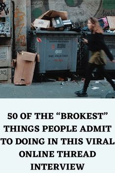 a man walking past a pile of boxes on the side of a building with graffiti