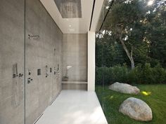 a modern bathroom with large rocks in the grass