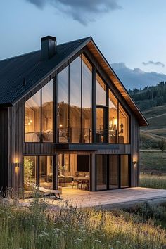 a large wooden house sitting on top of a lush green field