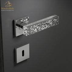 a bathroom door handle that has some lights on it and is decorated with silver glitter