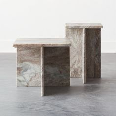 two marble tables sitting on top of each other