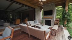 an outdoor living area with couches and chairs