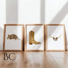 three framed pictures with animals on them in front of a white wall and wooden floor