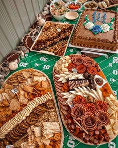 a table topped with lots of different types of food on plates and trays next to each other