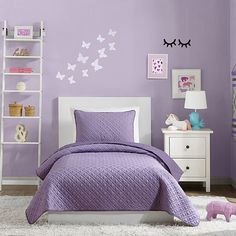 a bedroom with purple walls and white furniture in the corner is decorated with butterflies on the wall