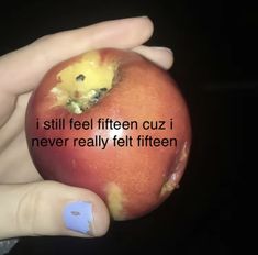 a person holding an apple with the words i still feel fifteen cuz i never really felt