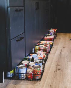 several cans of canned food are lined up on the floor