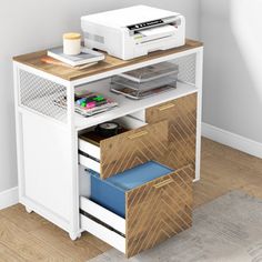 a white desk with drawers and a printer on the top, next to a wall