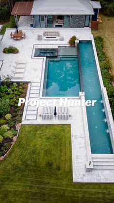 an aerial view of a house with a swimming pool and patio area in the foreground