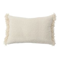 a white pillow with fringes on the front and back of it, against a white background