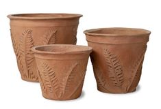 three clay pots with designs on them sitting next to each other