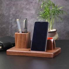 a cell phone and pen holder on a desk