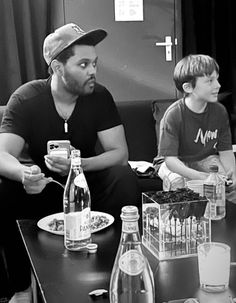 two men and a boy sitting at a table