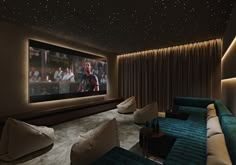 a home theater with two couches and a large screen