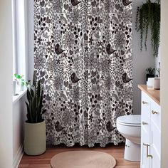 a white toilet sitting next to a shower curtain