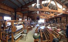 a large room filled with lots of wooden furniture and shelves full of books on top of them