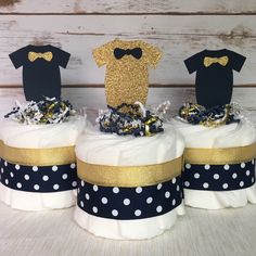 three cakes decorated with t - shirts and bow ties