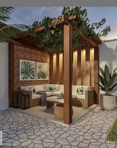 an outdoor living area with couches and potted plants