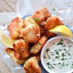 a blue plate topped with tater tots next to a bowl of ranch dressing