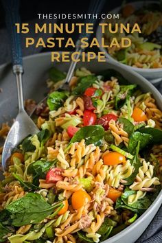 pasta salad with spinach and tomatoes in a white bowl