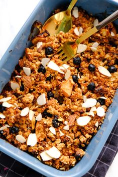 a blue dish filled with granola and nuts