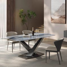 a dining room table with chairs and a vase on the table in front of it