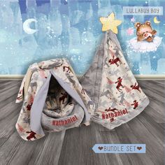 two baby blankets with animals on them sitting next to each other in front of a wall