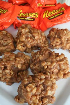 some cookies are on a white plate with orange bags