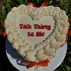 a heart shaped cake with the words talk thirty to me written on it