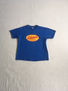 "vintage 1990s t-shirt Eddy's Groceries Olympia, WA Hanes Beefy T, 100% pre-shrunk cotton blue w/yellow/red print good vintage condition, light wear-light fade spots-see photos label size adult L-see below measures, lying flat, shoulder-19\" sleeve-7 1/2\" chest-20 11/2\" length-27\"" Blue Vintage Clothes, Vintage 90s Aesthetic Outfits, 90s Shirts Vintage, Vintage T-shirt, Vintage T Shirt Design, 90s Clothes, Class Shirt, Corner Store, Baggy Clothes