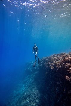 a man swimming in the ocean with his scuba gear on