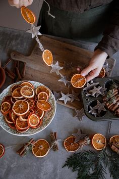 an overhead view of orange slices and cinnamons on a plate with star decorations around them