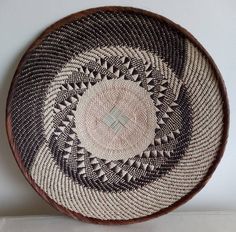 a brown and white basket sitting on top of a table