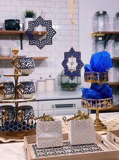 three tiered trays with blue and gold decorations on them in a kitchen area